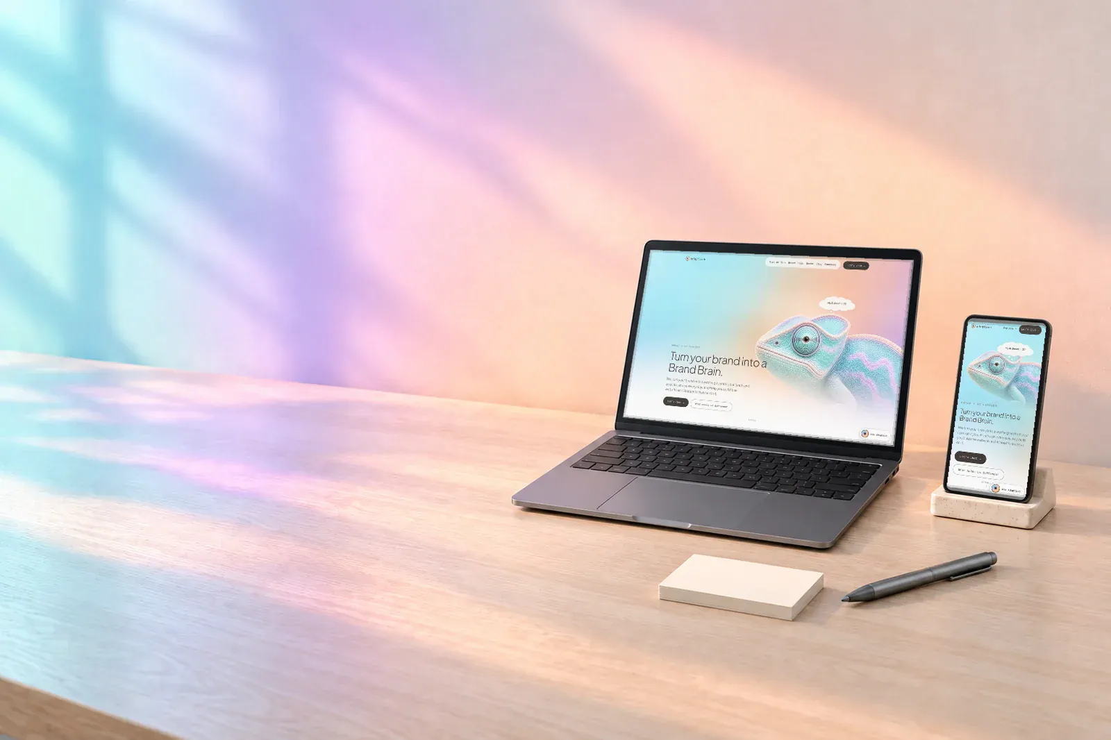 A laptop and a phone on a pale desk, both showing an Adaptius-style website, in soft plasma window light